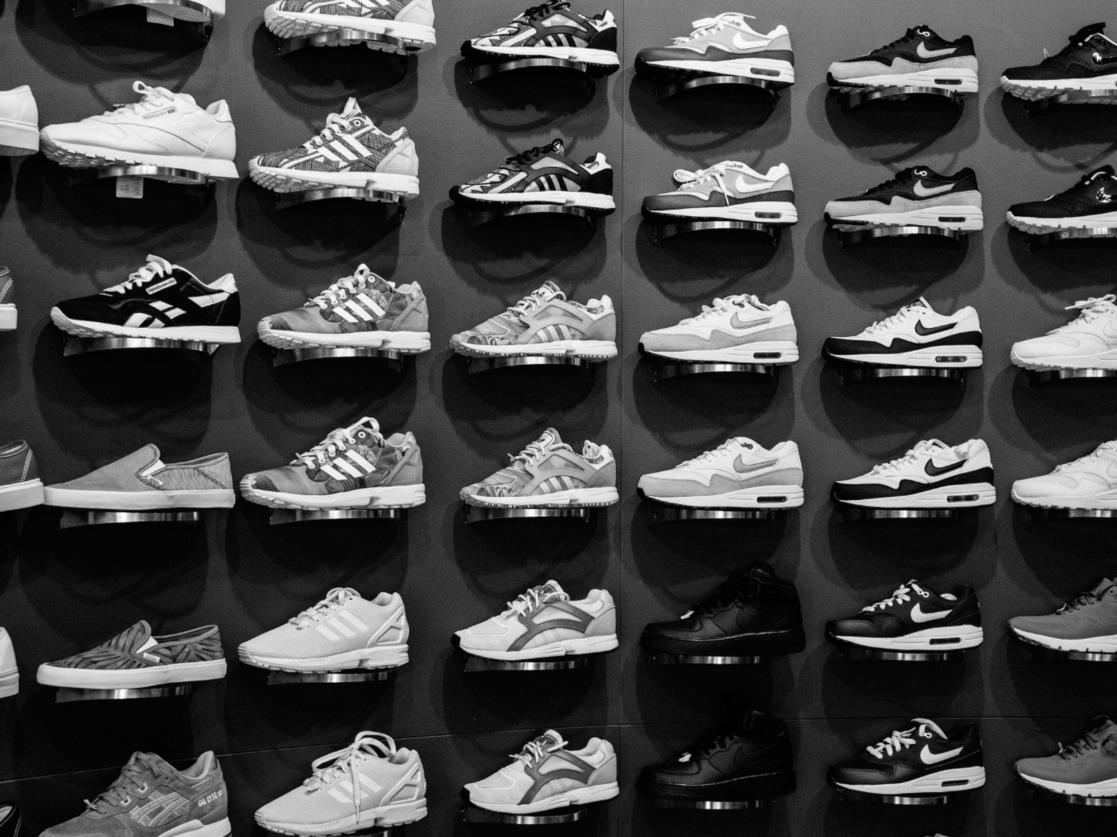 Retail footwear presented on individual display stands, illustrating commercial display stand applications.