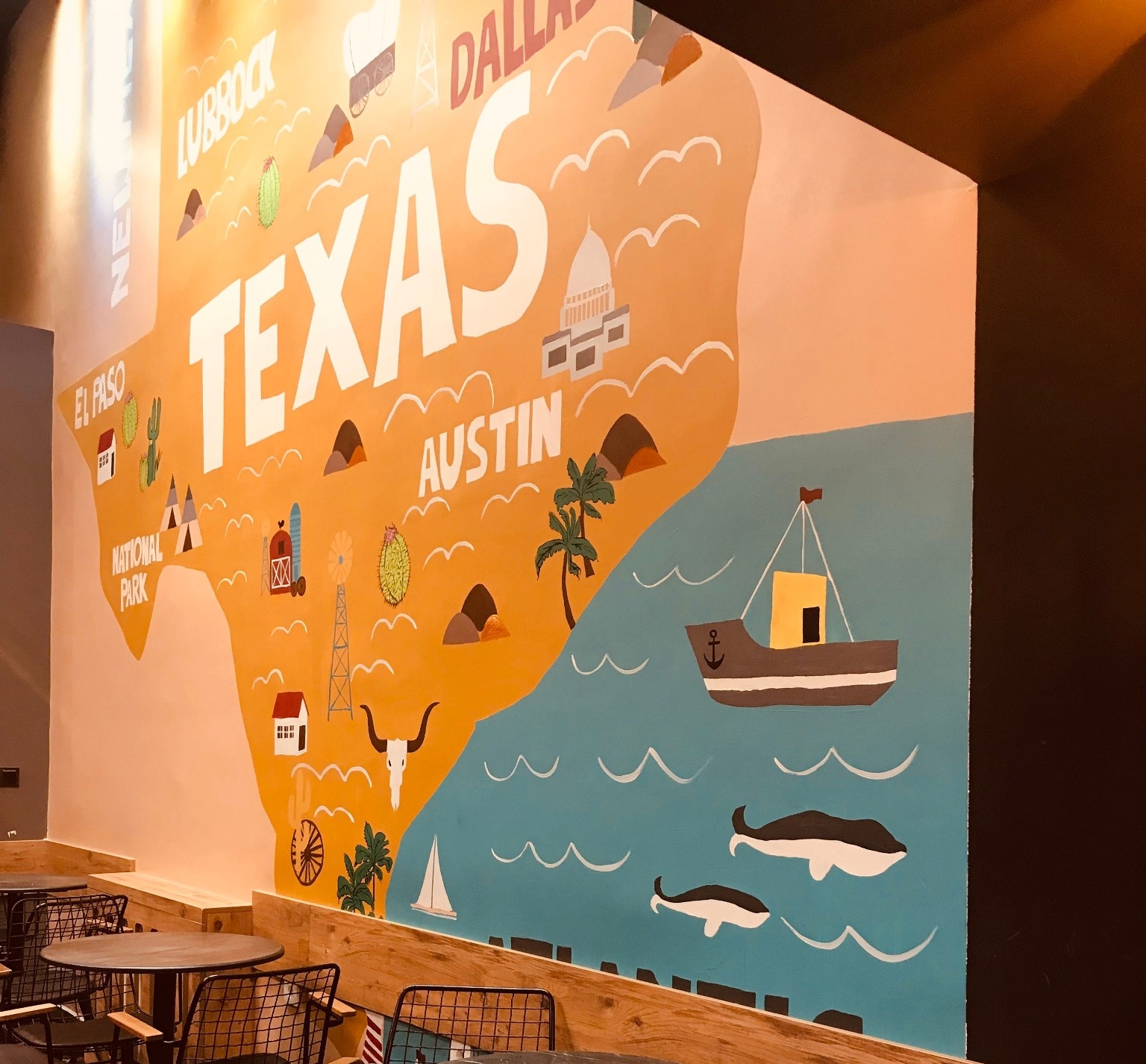 A large branded wall mural applied across a hospitality interior.
