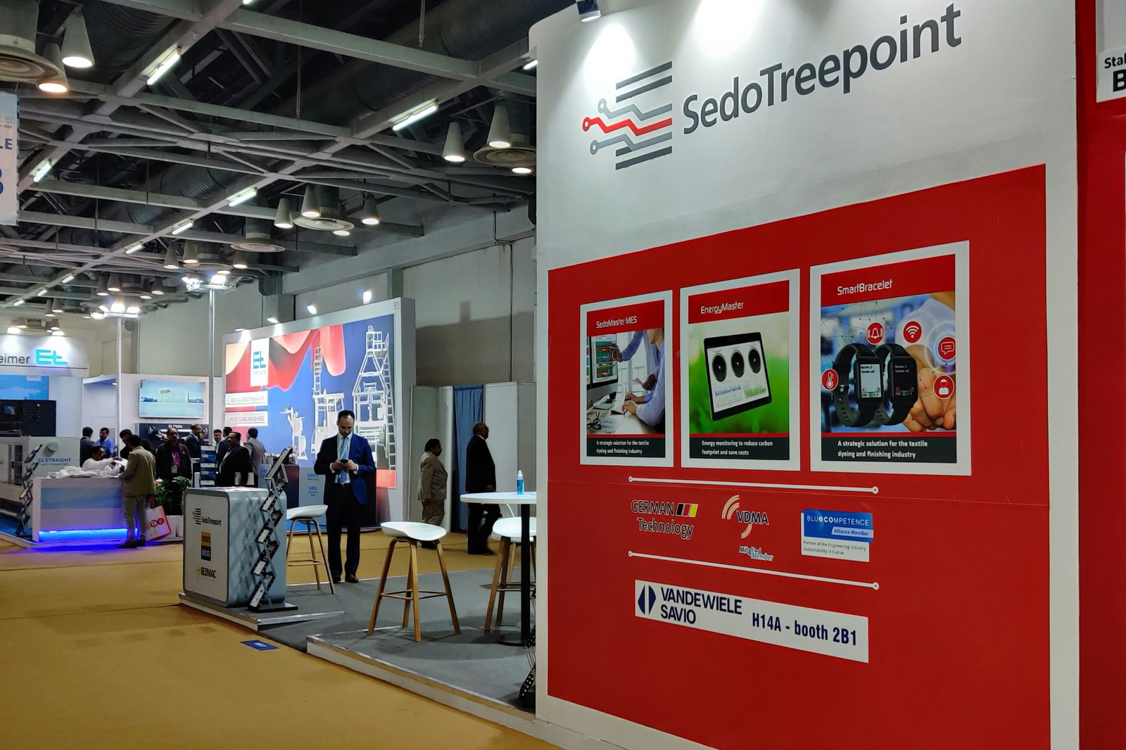 Modular exhibition stand with branded graphics, presentation surfaces and visitor space.