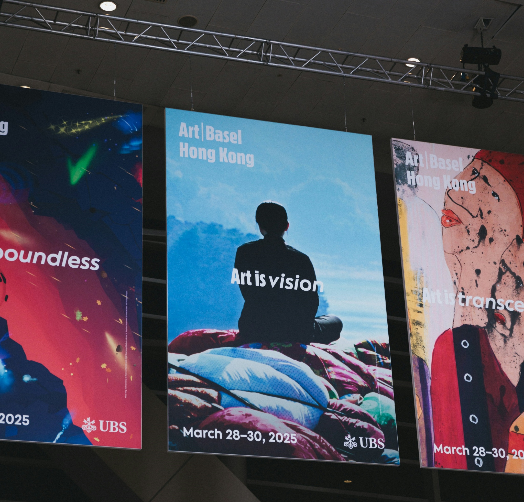 Large hanging exhibition graphics displayed across an event venue.