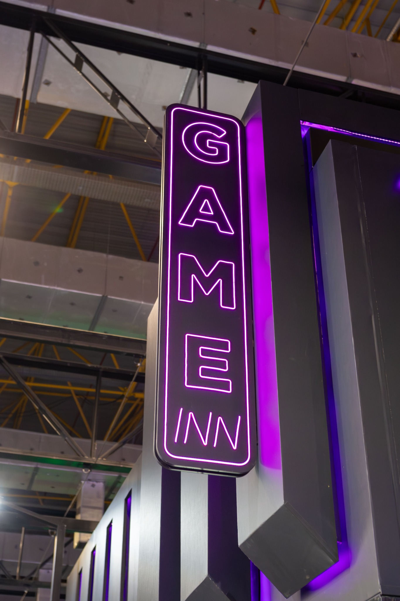 Illuminated exhibition sign in a refined commercial display environment.