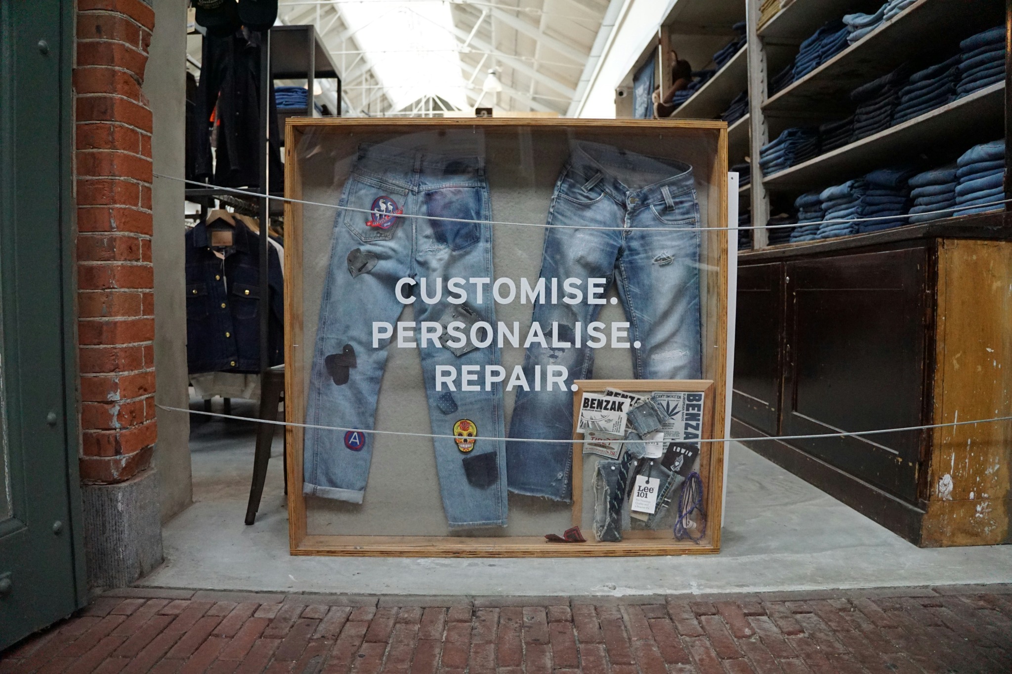 Retail display installation featuring customised denim presentation and in-store promotional branding.