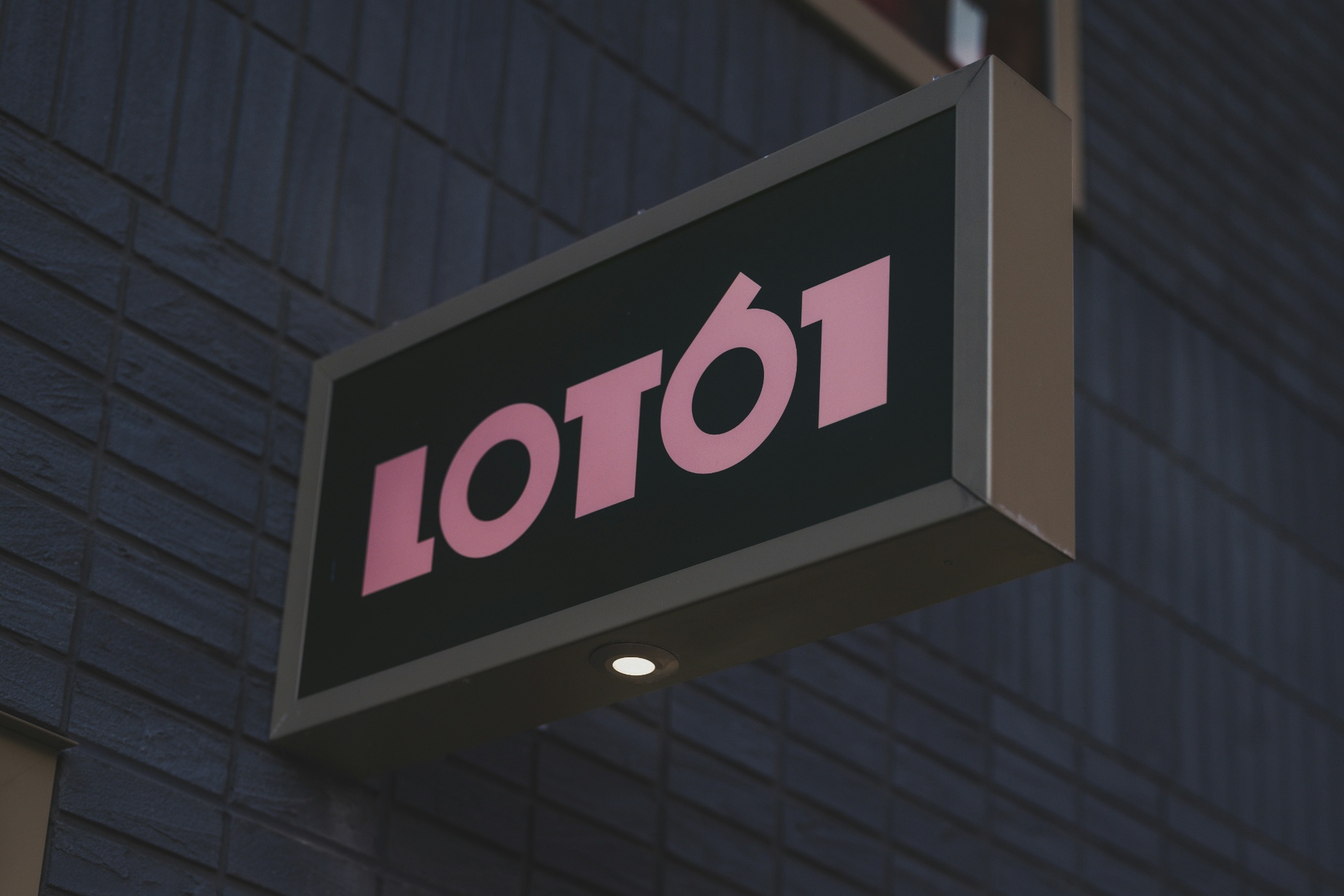 Exterior projecting sign mounted to a commercial façade.