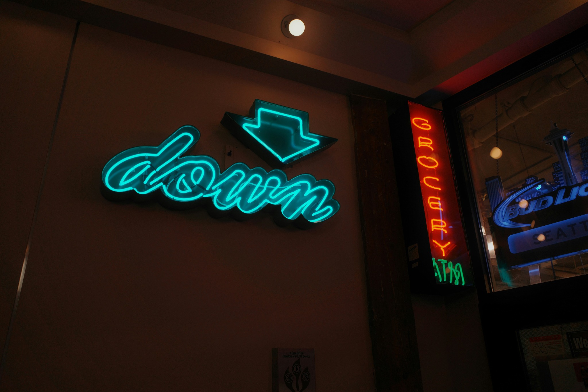 Illuminated neon sign glowing in an interior evening setting.