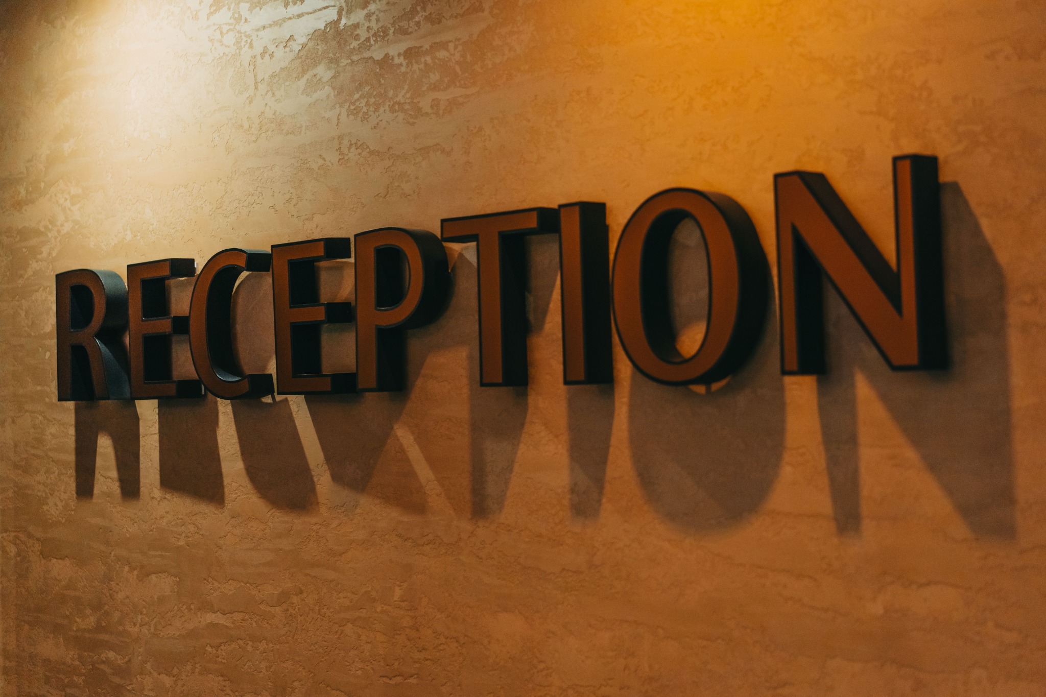 Elegant reception sign installed on an interior wall.