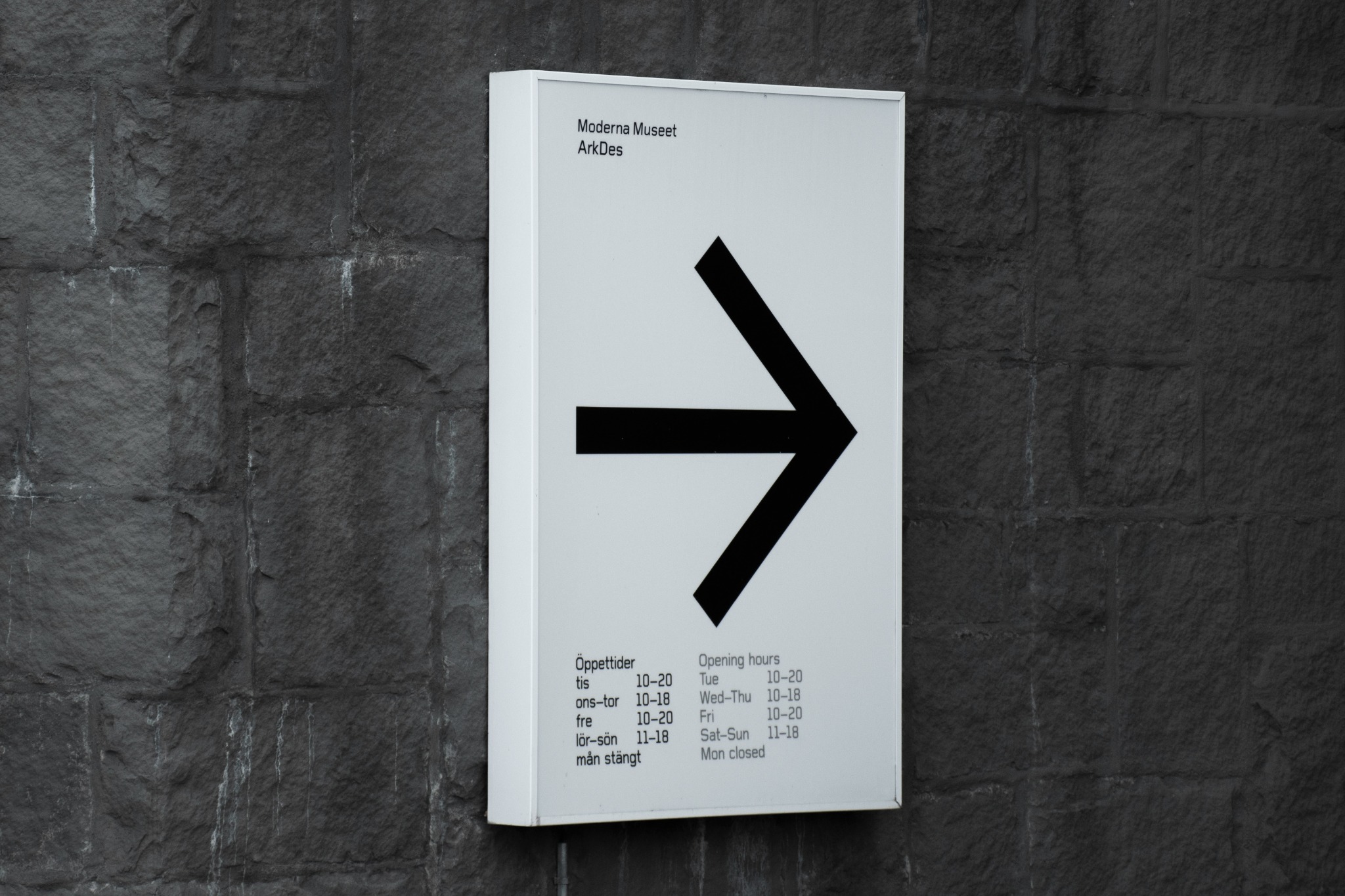 Directional sign guiding visitors through a public interior.